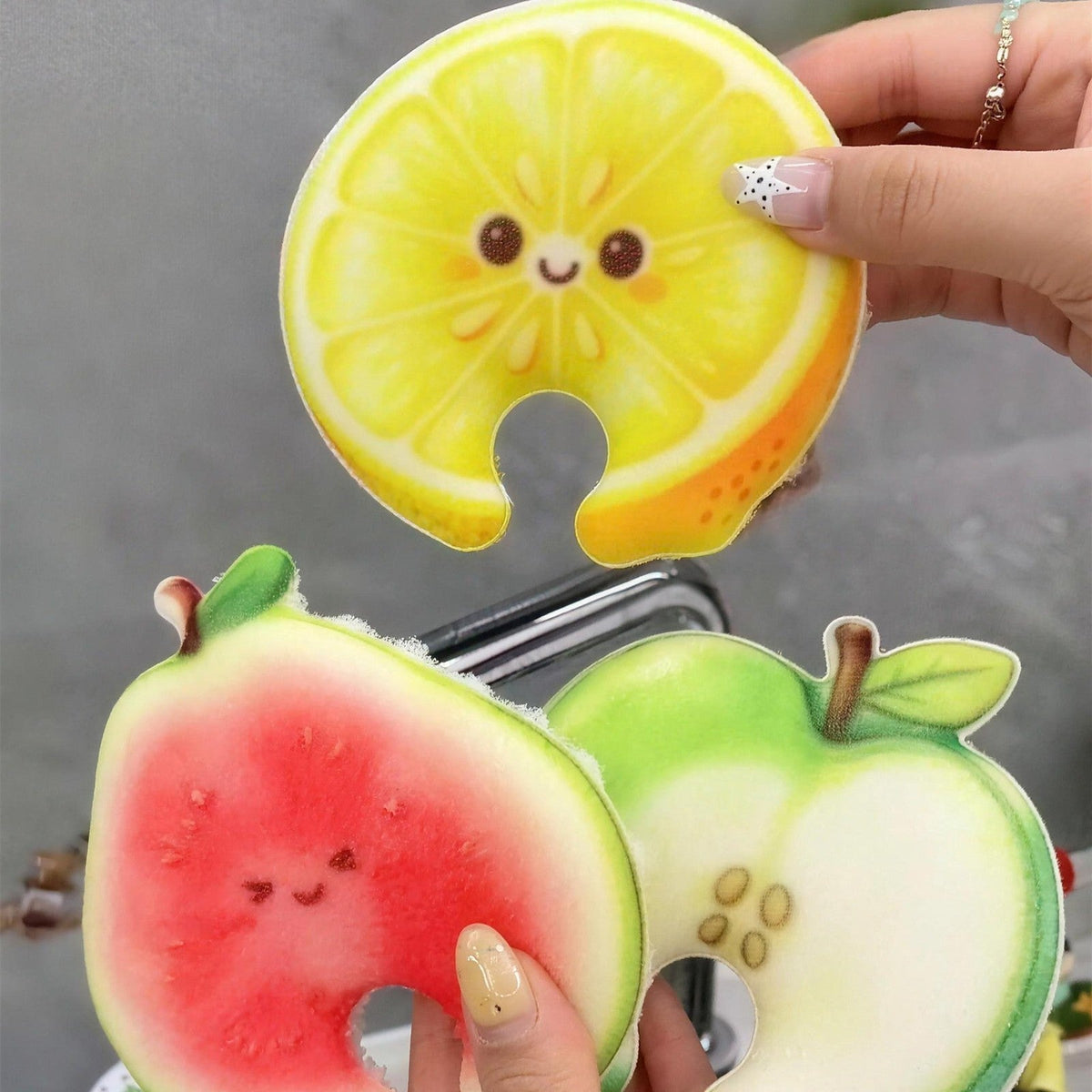 Lemon, guava and apple Frubby sponges in hand