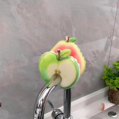 Real photo: apple and guava Frubby sponges hanging on a faucet