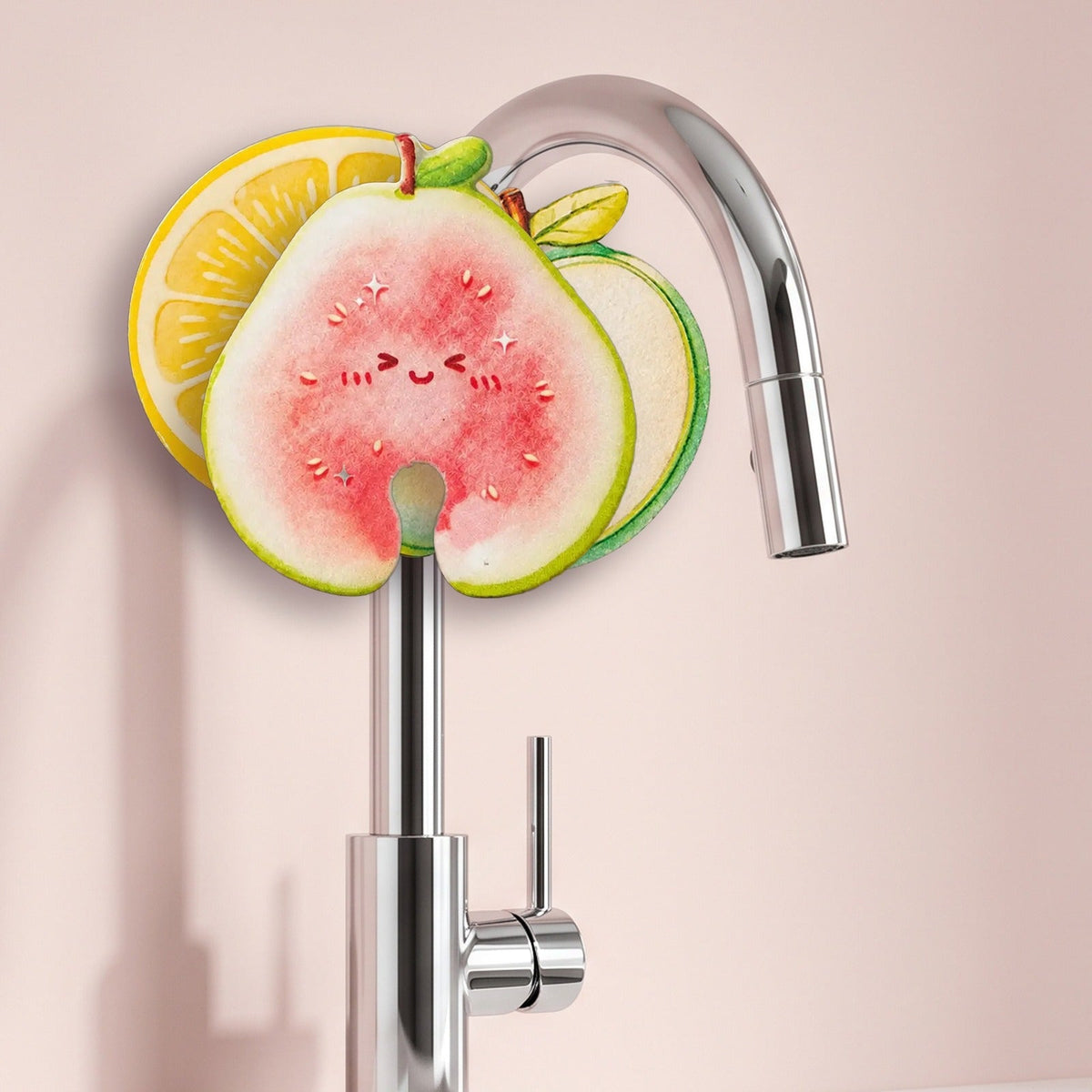 Frubby apple, guava and lemon sponges hanging on a kitchen faucet